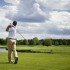Male golf player teeing off golf ball from tee box