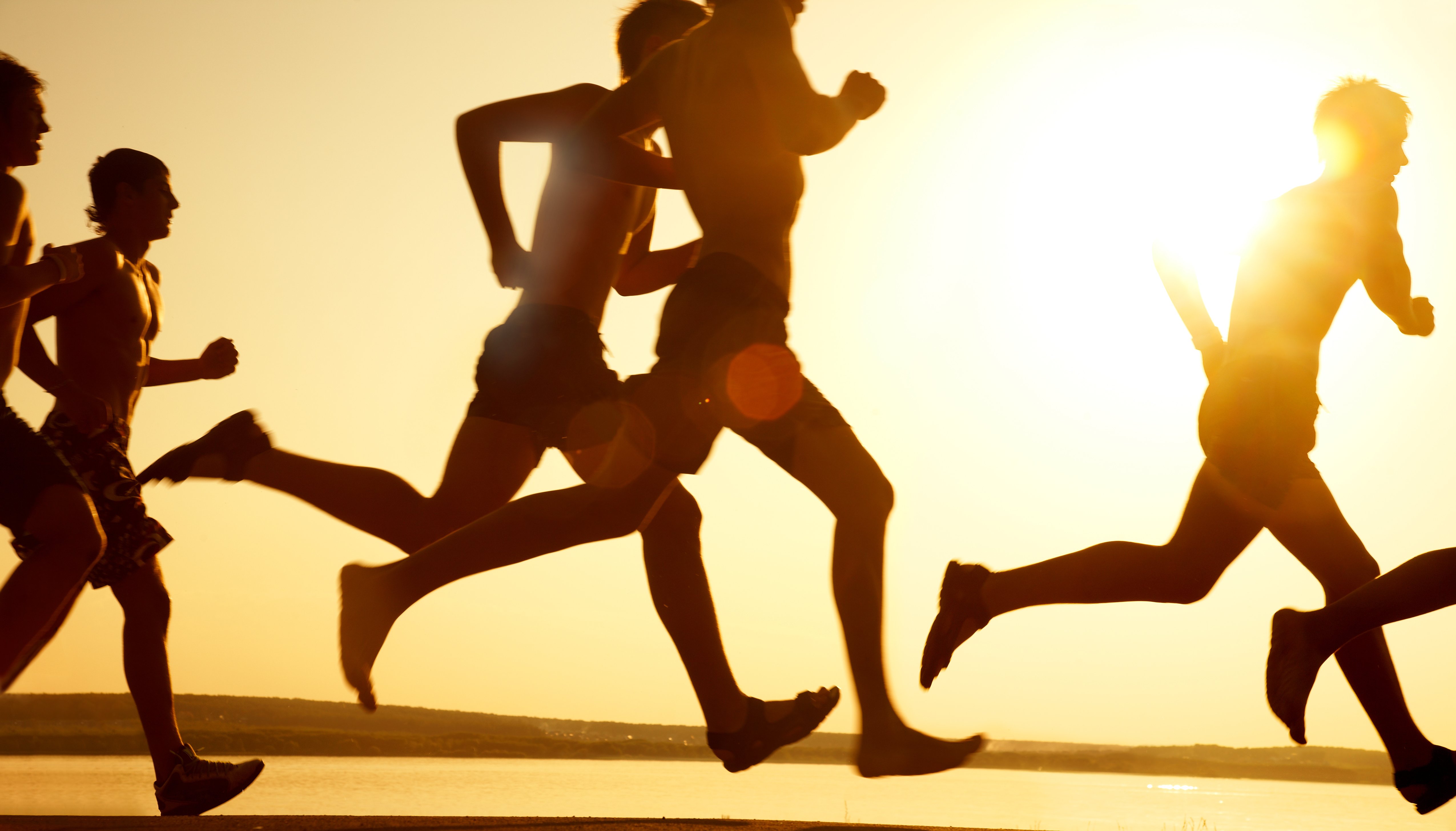 group of people running on beach _82385032