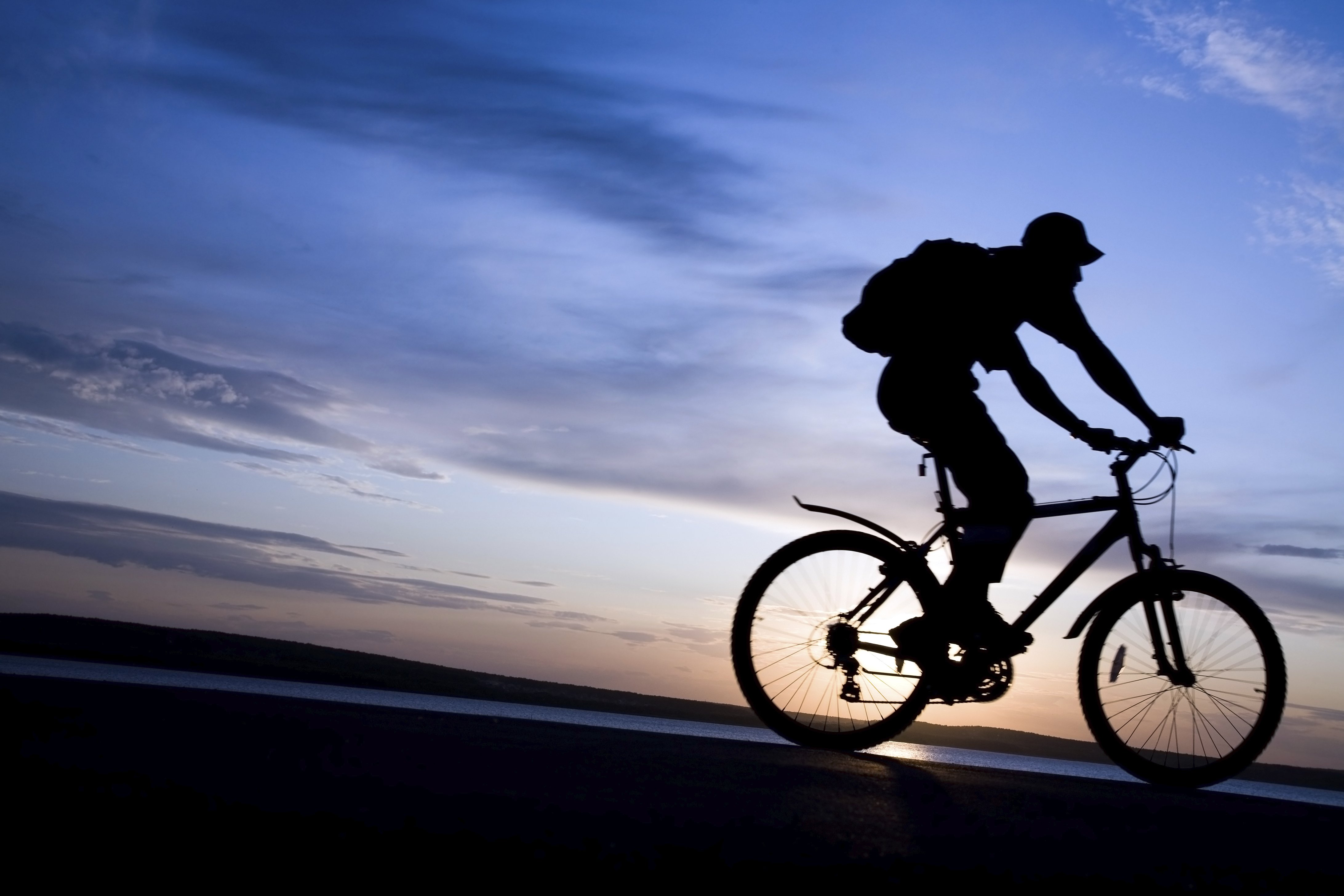 silhouette of cyclists in motion