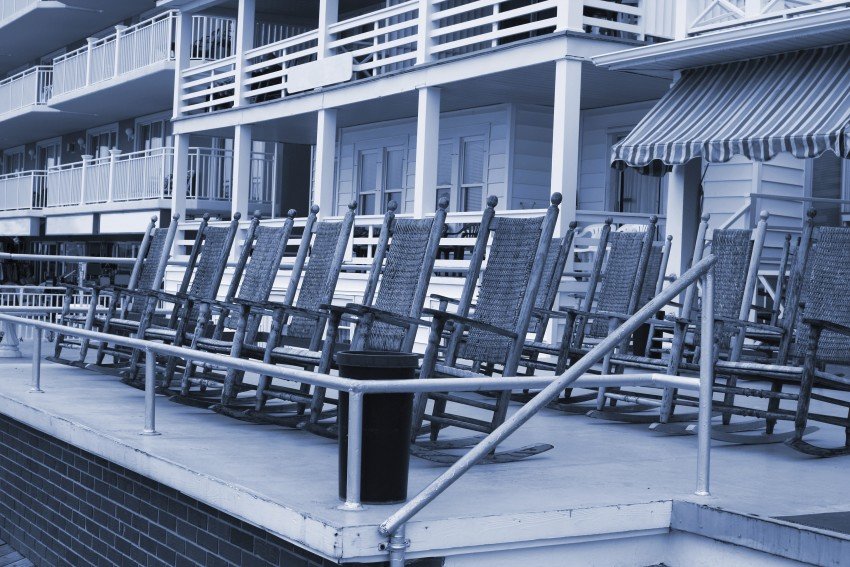 rocking chairs on boardwalk at hotel_89471288