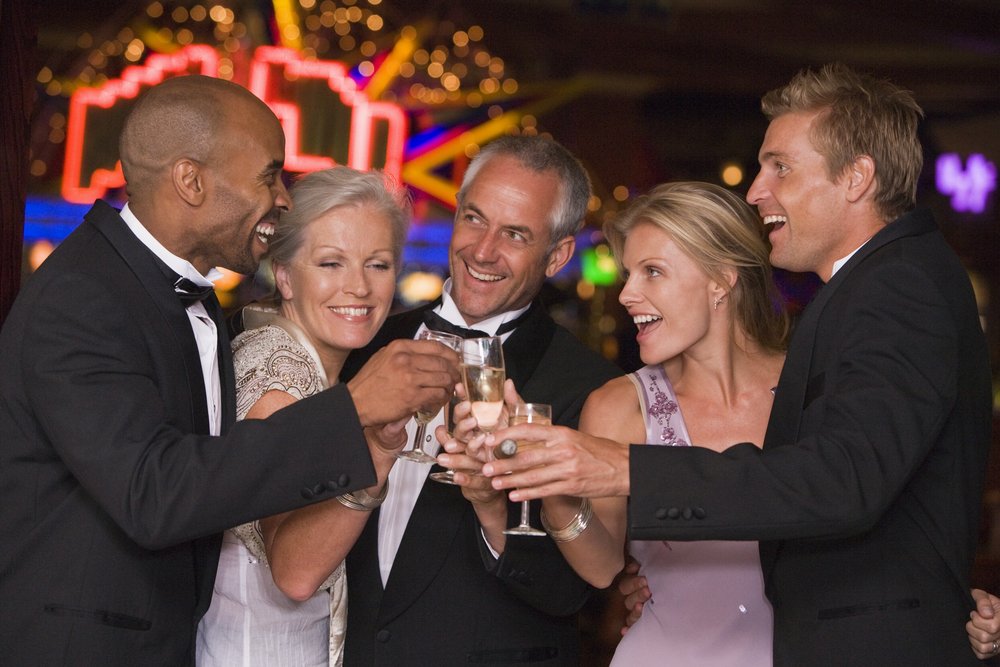 group in formal wear toasting
