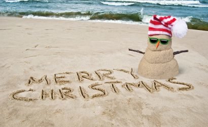 christmas in july events in ocean city with sand snowman with santa hat on the beach
