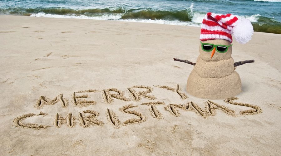 christmas in july events in ocean city with sand snowman with santa hat on the beach