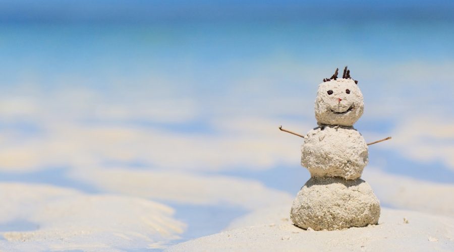 snowman made of sand on the beach