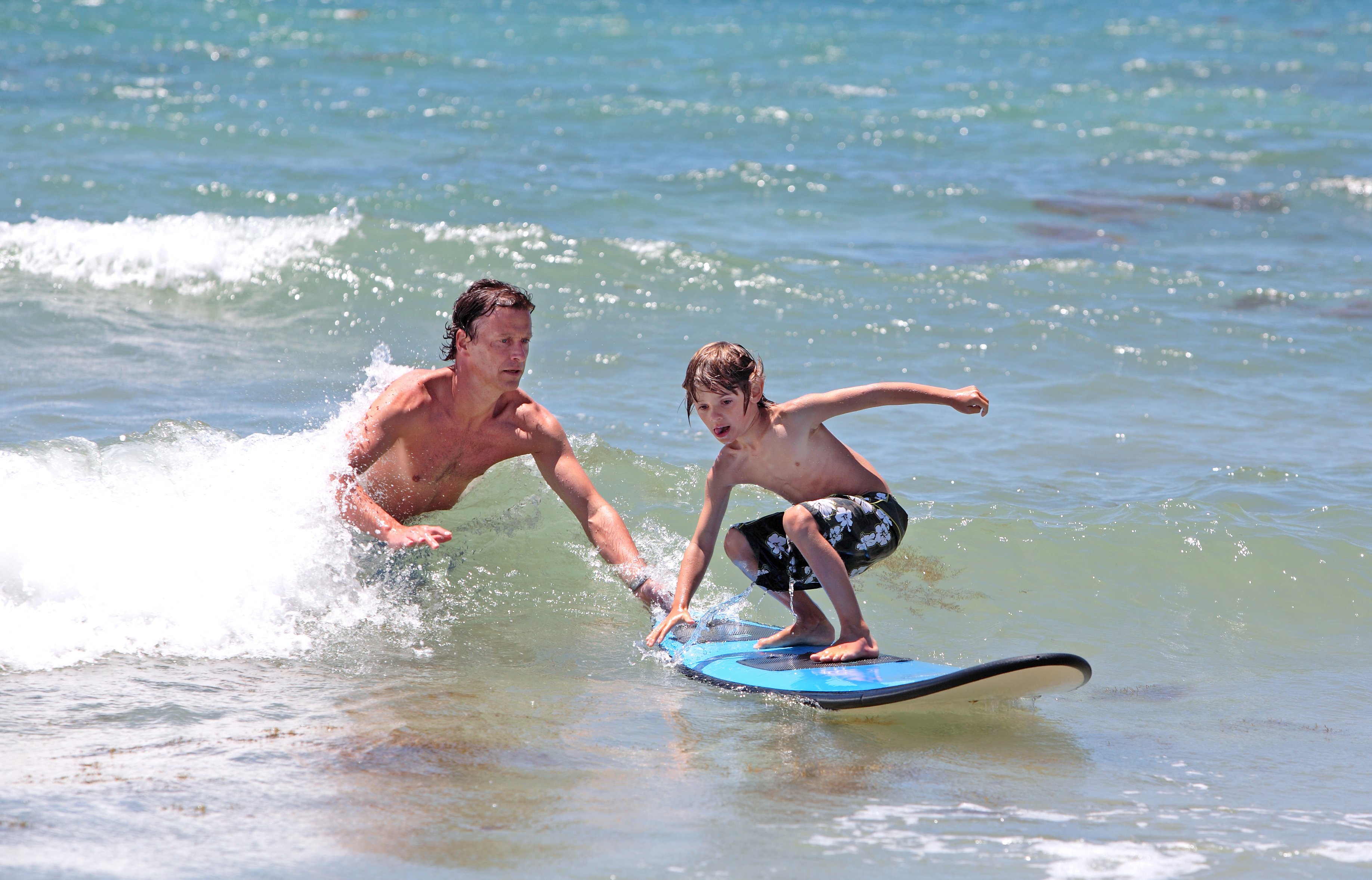 father teaching son to surf ShoreBread Eastern Shore Lifestyle Magazine