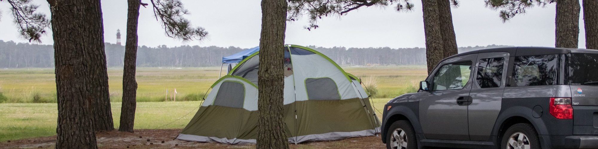 Chincoteague Island KOA one of several campgrounds on delmarva with tent and view of lighthouse