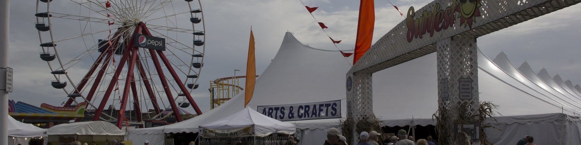 sunfest festival in ocean vity with arts and crafts tent and Ferris wheel