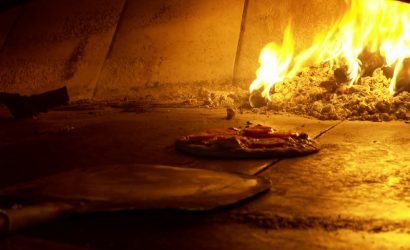 wood fired pizza in oven on International Beer and Pizza Day