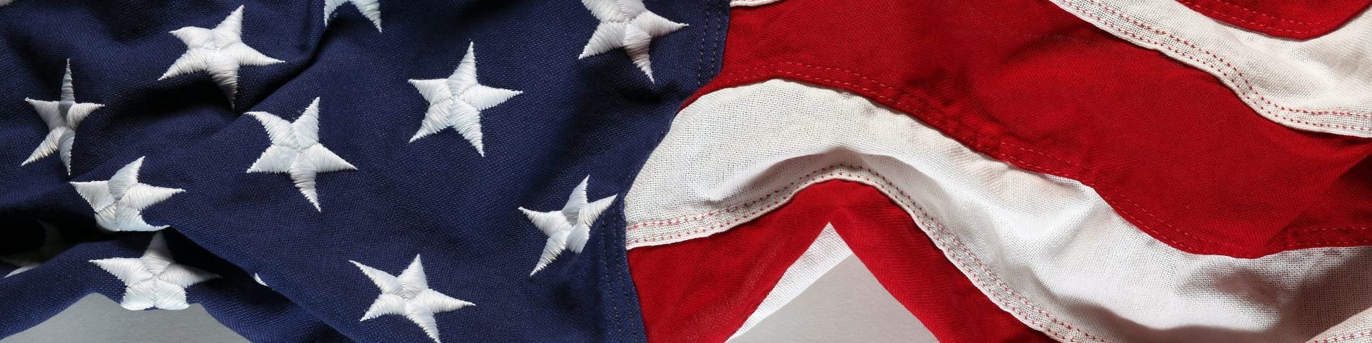 An American Flag waving on a white background for veteran's day