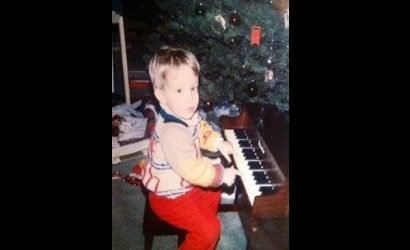 young child at a piano in front of a christmas tree for Brian's Christmas Songbook Concert