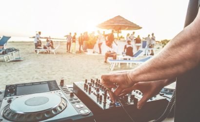DJ playing on beach for crowd
