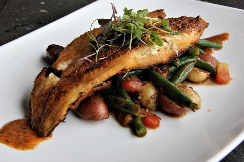 pan seared fish over vegetables