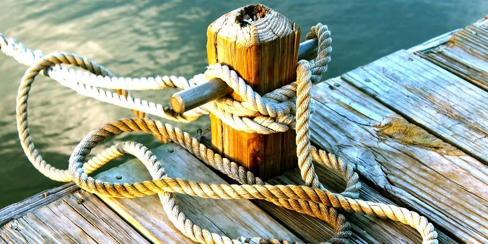 ropes at boat dock slip in harbor