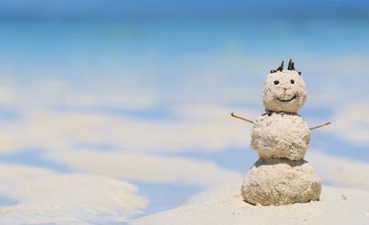 snowman made of sand on the beach