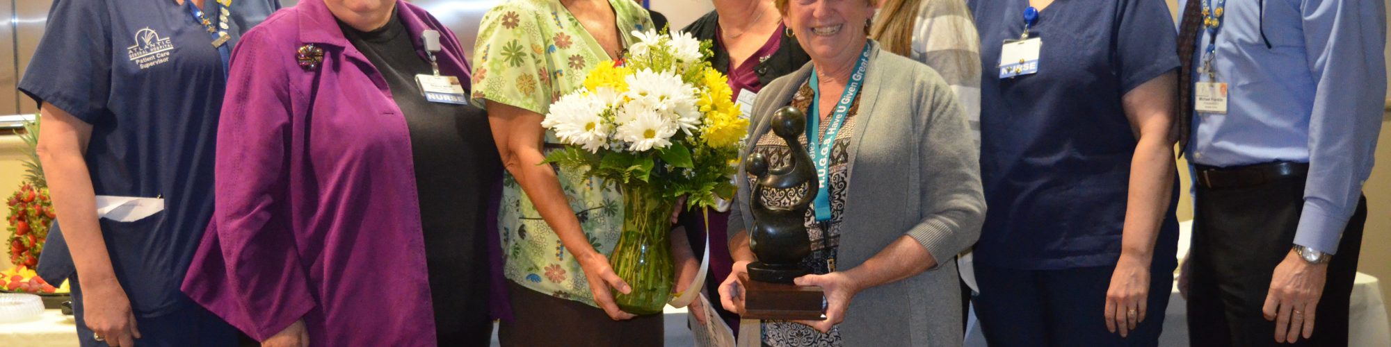 Nurse accepting the DAISY Lifetime Achievement Award from Atlantic General Hosptial